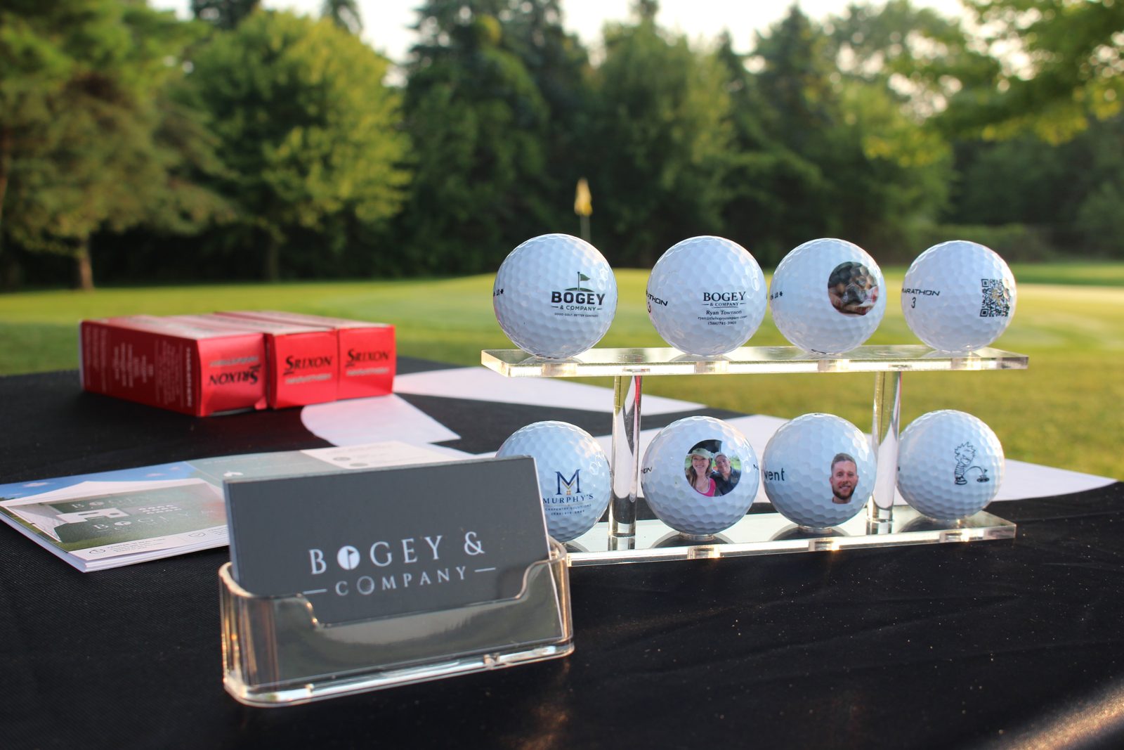 Display stand of custom printed golf balls at an event table
