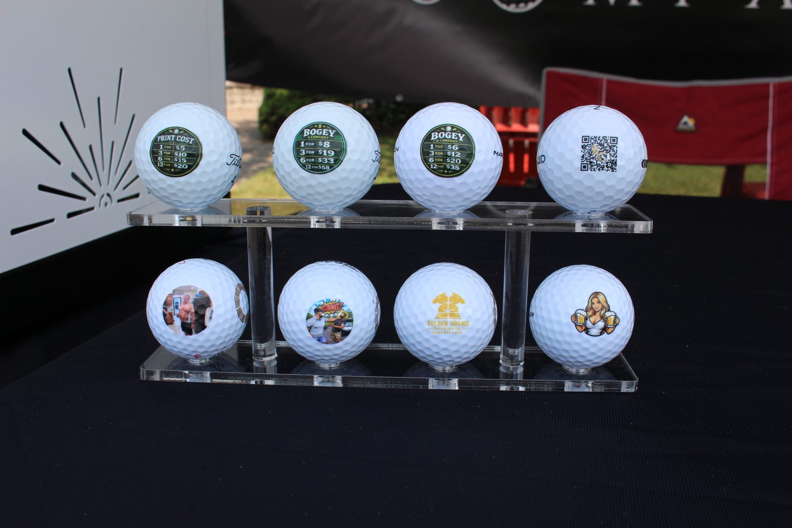 Row of golf balls printed with custom logos and photos